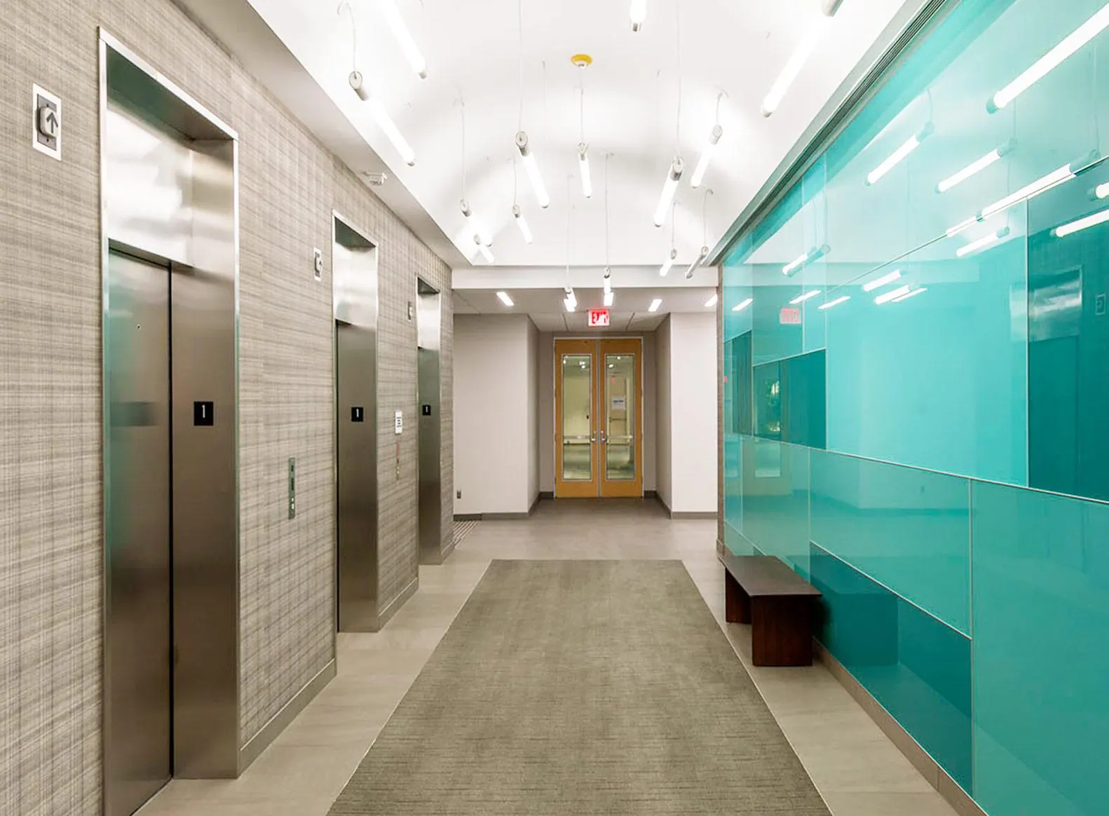Elevator lobby with teal glass wall